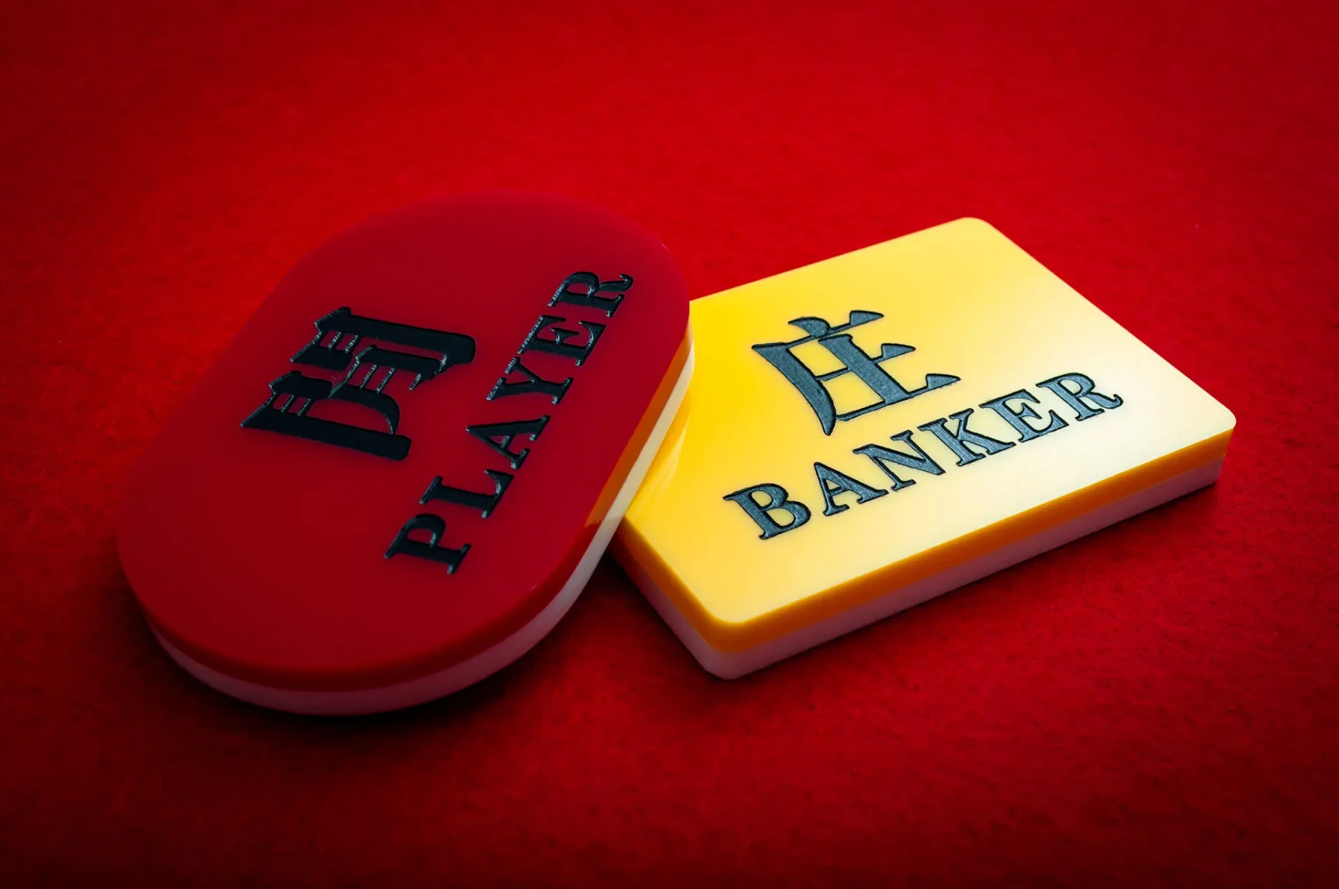 Player and banker tokens on red background